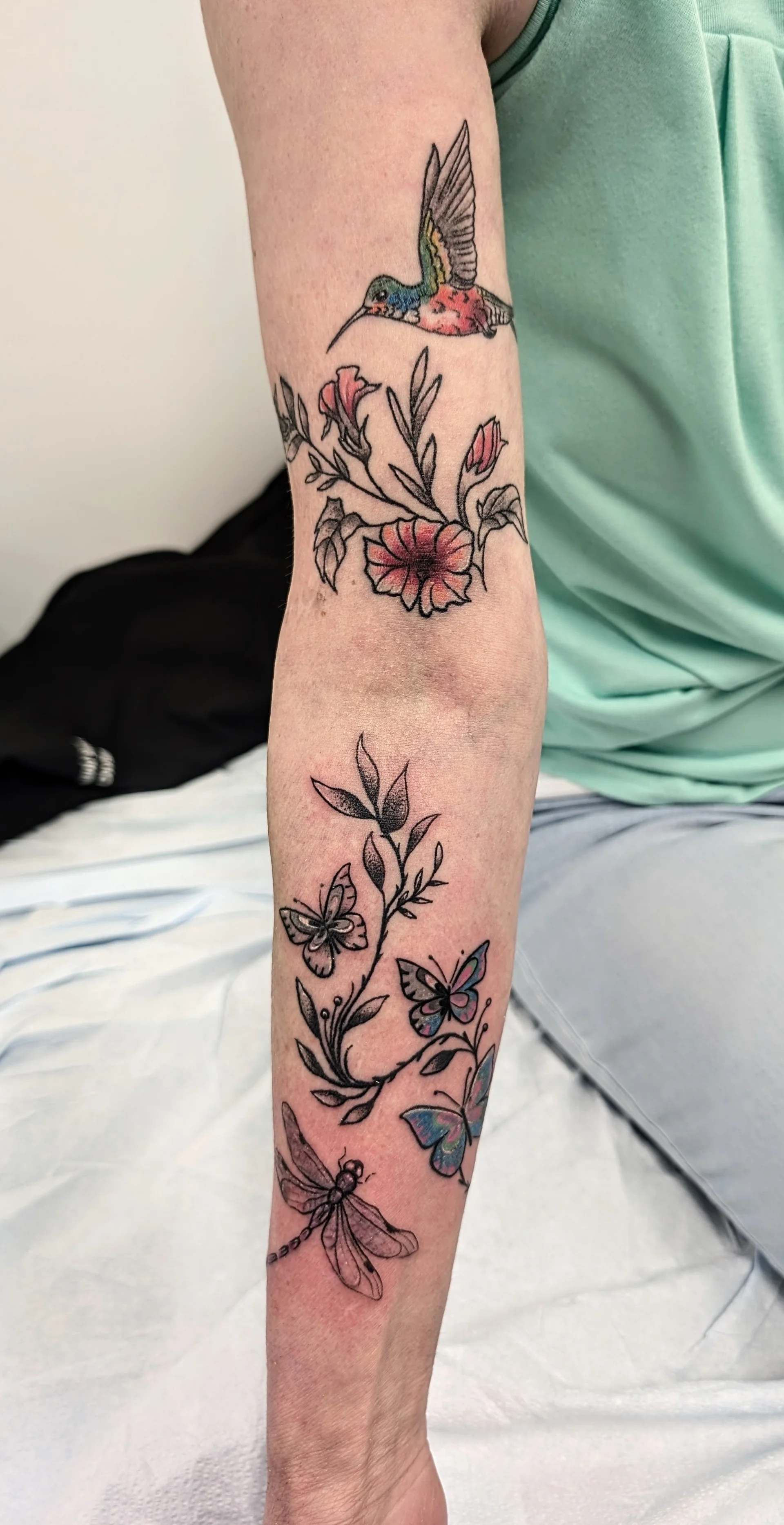 Hummingbird Flower Arm Piece - illustrative tattoo by Saskatoon tattoo artist
