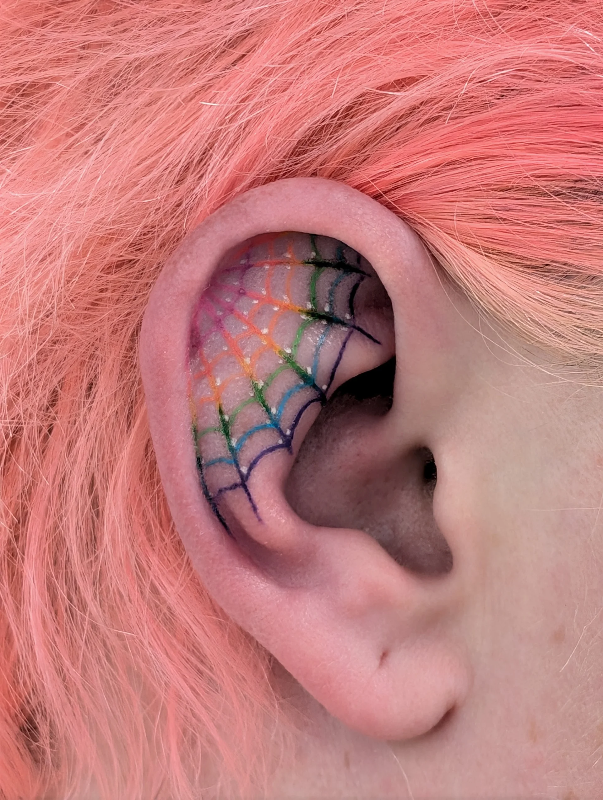 Rainbow Spider Web Ear - illustrative tattoo by Saskatoon tattoo artist