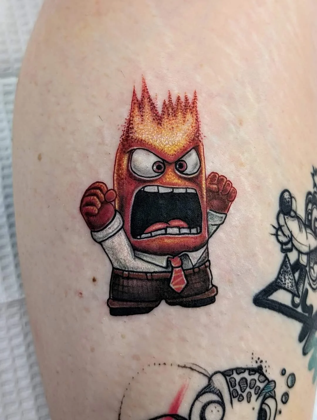 Angry Fire Character - new school tattoo by Saskatoon tattoo artist
