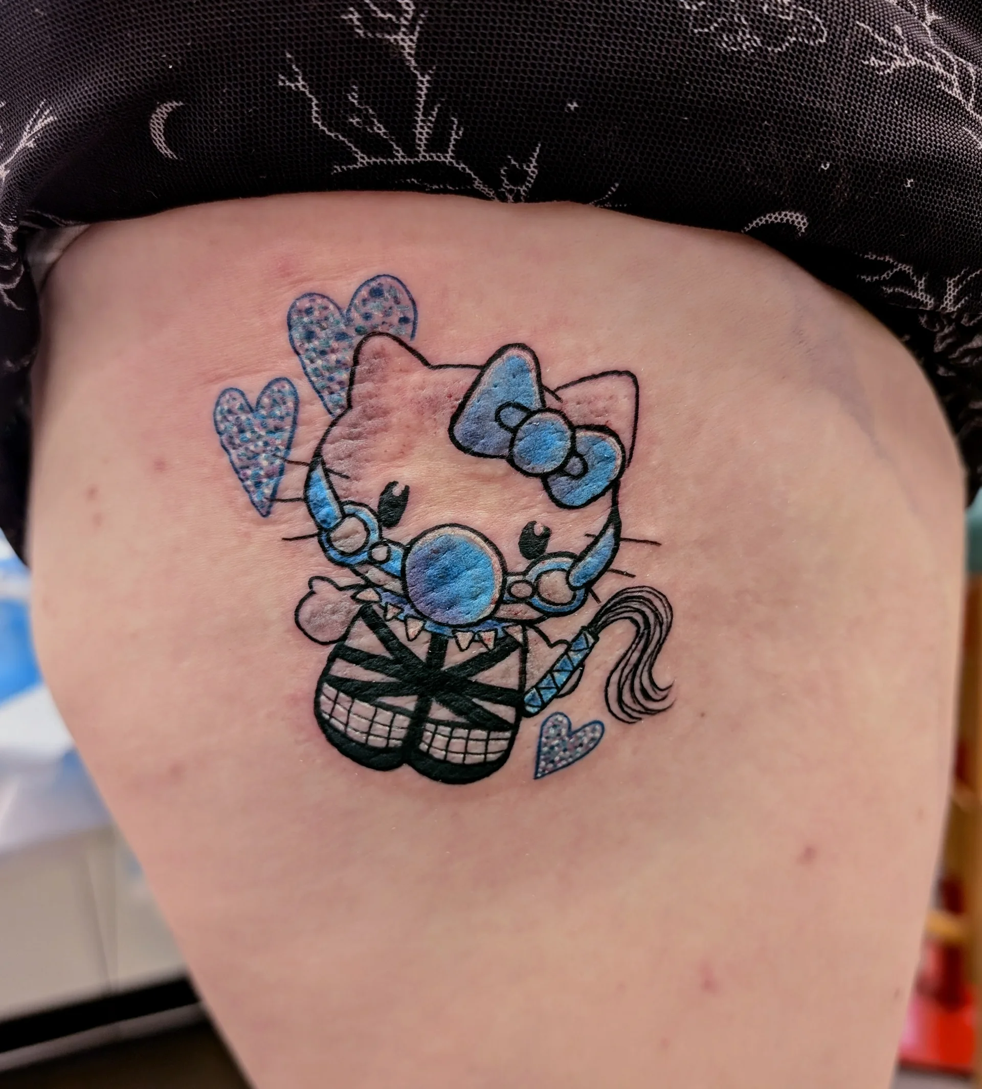 Hello Kitty Closeup - new school tattoo by Saskatoon tattoo artist