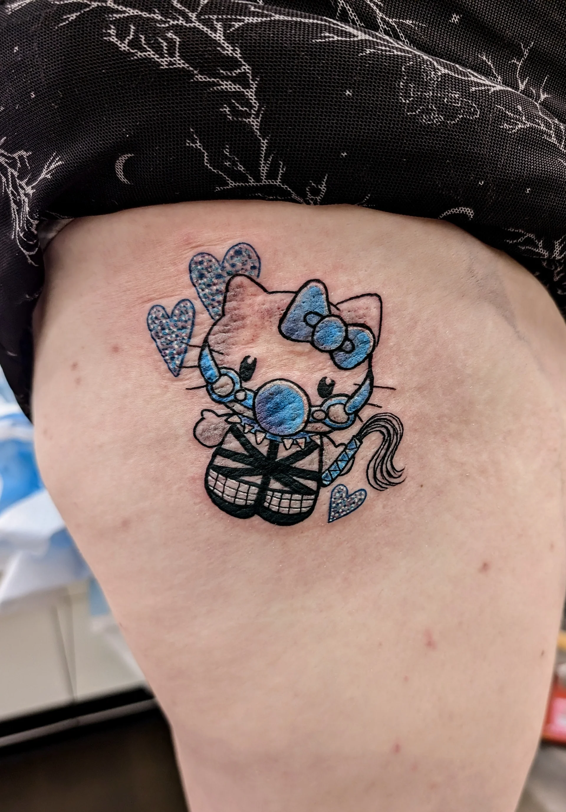 Hello Kitty Mask Whip - new school tattoo by Saskatoon tattoo artist